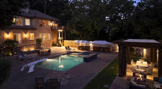outdoor pool featuring an outdoor living space with a fire pit, a jacuzzi, a gazebo, and a patio area