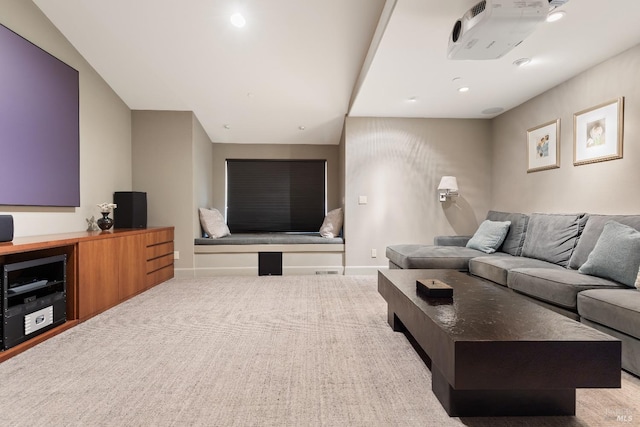 carpeted living room with recessed lighting and baseboards