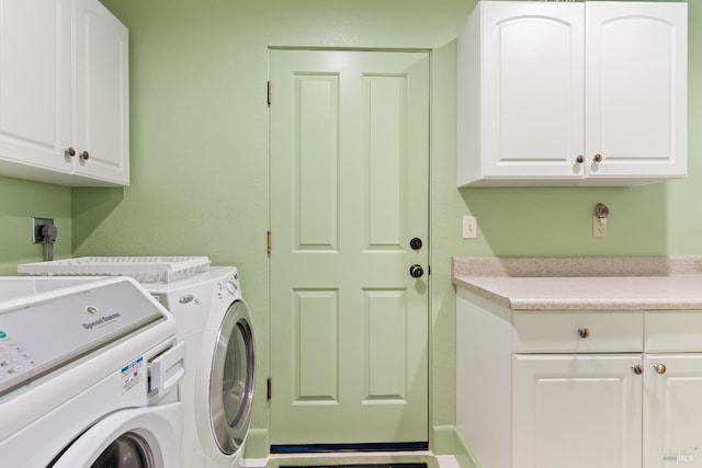 laundry area with washer and clothes dryer and cabinet space