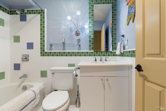 full bath featuring a bathtub, vanity, tile walls, and toilet