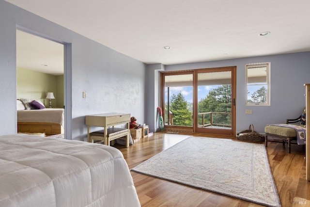 bedroom featuring recessed lighting, access to exterior, and wood finished floors