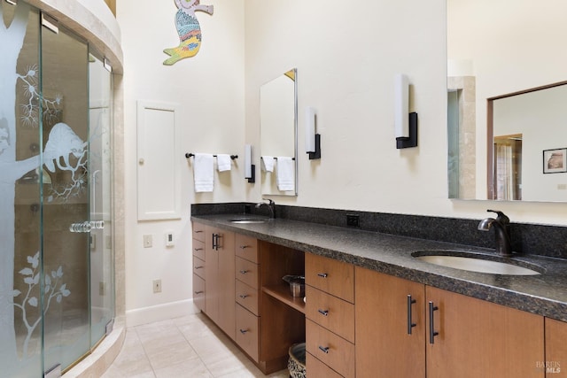 bathroom featuring a sink, tile patterned flooring, a shower stall, and double vanity