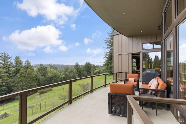 balcony featuring a grill and a forest view