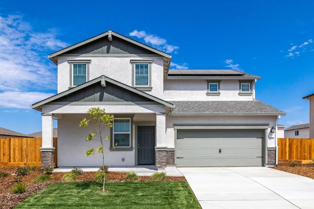 view of front facade featuring stucco siding, driveway, an attached garage, solar panels, and fence