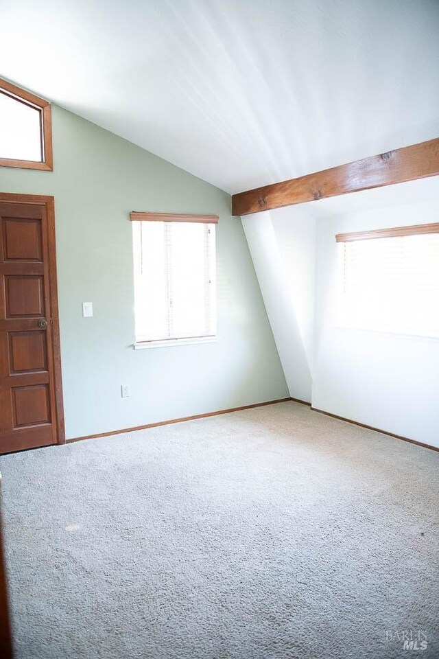 bonus room featuring vaulted ceiling, carpet, and baseboards