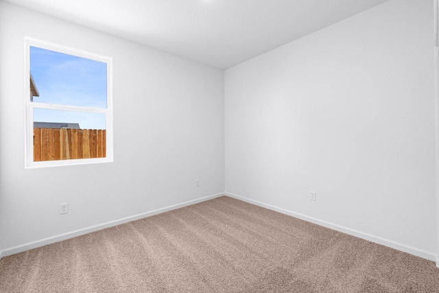 empty room with baseboards and carpet floors