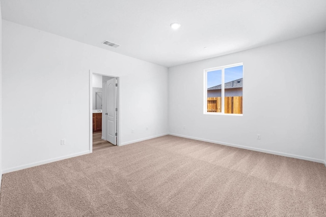 carpeted spare room with visible vents, baseboards, and recessed lighting