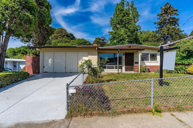 single story home with a fenced front yard and a front lawn