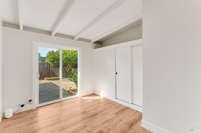 unfurnished bedroom with access to outside, lofted ceiling with beams, and light wood-style flooring
