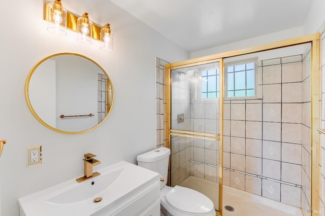 bathroom with vanity, toilet, and a shower stall