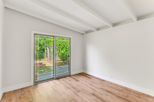 unfurnished room with baseboards, lofted ceiling with beams, and wood finished floors