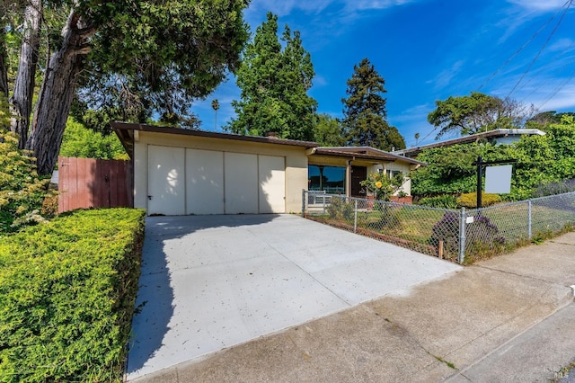 ranch-style house featuring stucco siding and fence