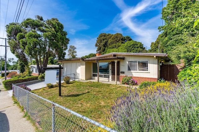 bungalow with brick siding, a fenced backyard, a front lawn, and a chimney