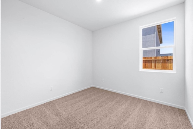 spare room with carpet floors and baseboards