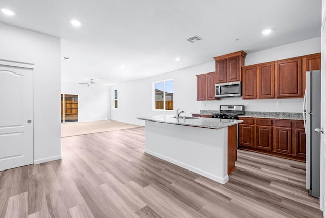 kitchen with visible vents, a sink, light wood-style flooring, and appliances with stainless steel finishes