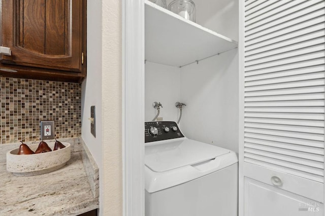 washroom with laundry area and washer / dryer