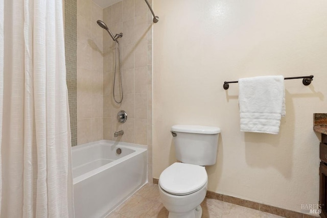 full bath with tile patterned floors, toilet, baseboards, and shower / tub combo with curtain