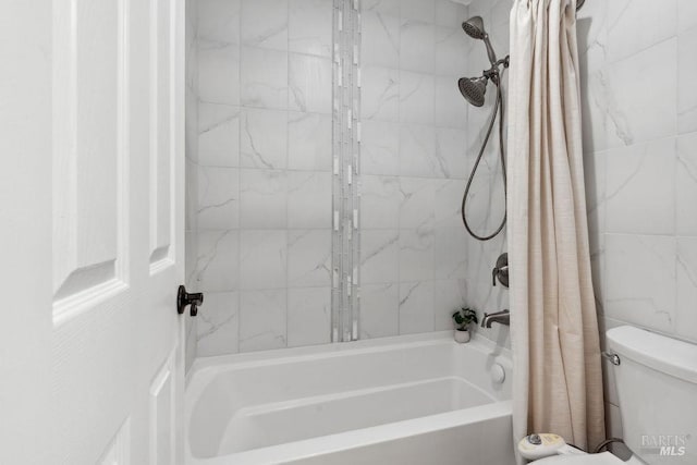 bathroom with shower / bath combination with curtain and toilet