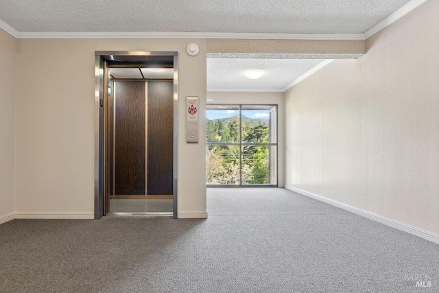 carpeted empty room featuring elevator, baseboards, ornamental molding, and a textured ceiling