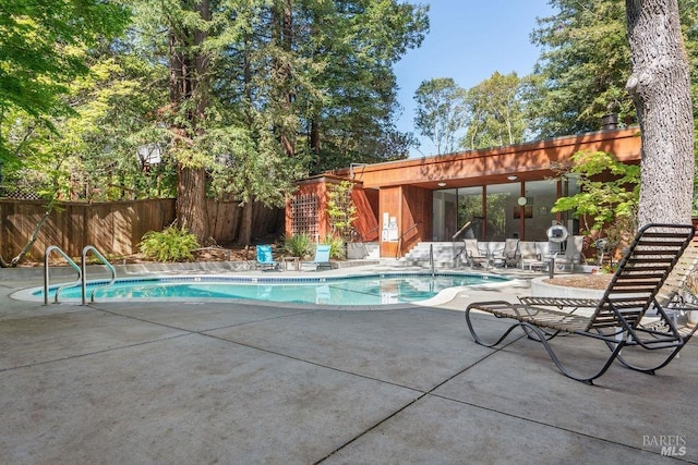 view of pool with a fenced backyard, a fenced in pool, and a patio area