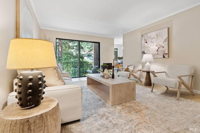 living room with baseboards, crown molding, and light wood-style flooring