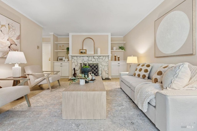 living room featuring a fireplace, built in features, and ornamental molding