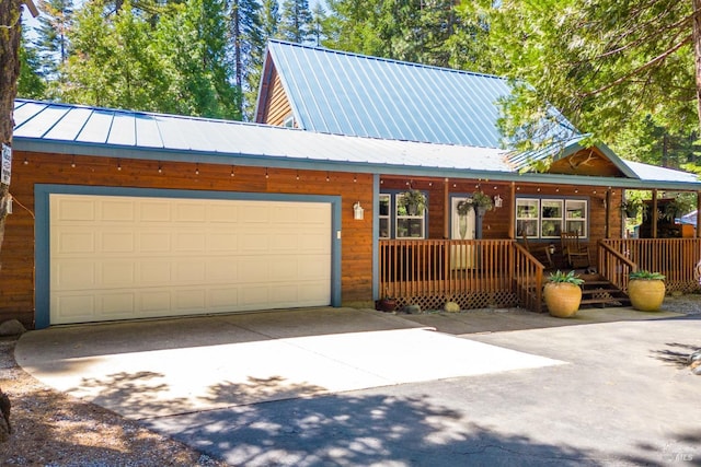 35725 Corinthians Way, Shingletown, CA 96088 - chalet / cabin featuring driveway, a garage, and metal roof