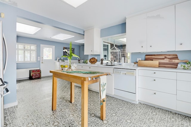 2 Beach Rd, Belvedere, CA 94920 - kitchen featuring dishwasher, white cabinets, light countertops, and a sink