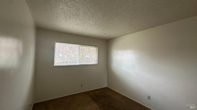175 Nehoc Ct, Ukiah, CA 95482 - empty room with dark carpet and a textured ceiling