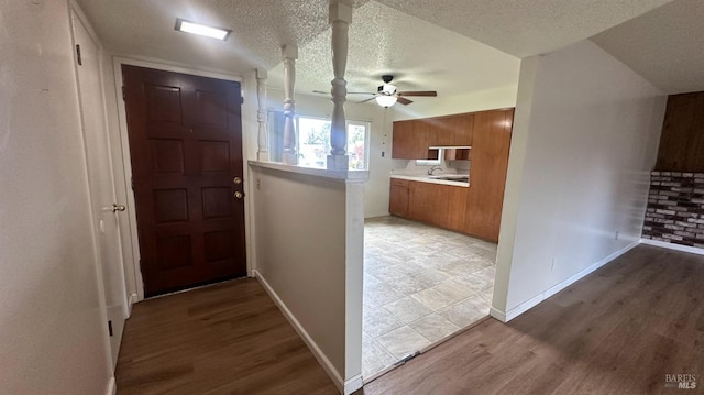 175 Nehoc Ct, Ukiah, CA 95482 - corridor featuring light wood-type flooring, a sink, baseboards, and a textured ceiling