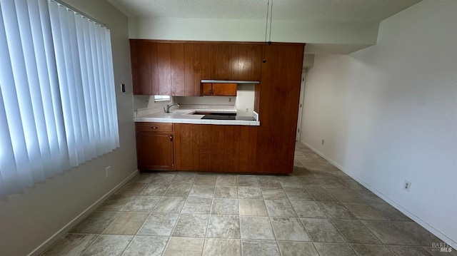 175 Nehoc Ct, Ukiah, CA 95482 - kitchen with tile counters, a textured ceiling, baseboards, and brown cabinets