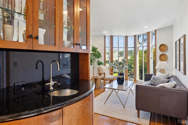 45 Bella Vista Ave, Belvedere, CA 94920 - bar featuring decorative backsplash, a wall of windows, wood finished floors, recessed lighting, and a sink