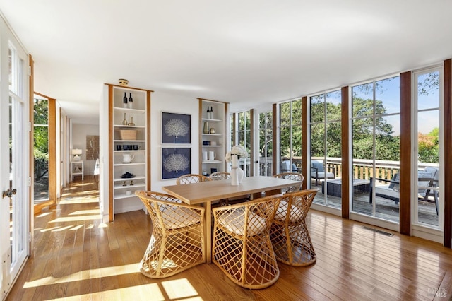 45 Bella Vista Ave, Belvedere, CA 94920 - dining area featuring visible vents, floor to ceiling windows, and hardwood / wood-style floors
