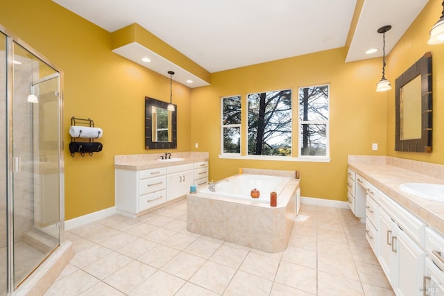 full bath with a shower stall, baseboards, two vanities, a sink, and tile patterned flooring