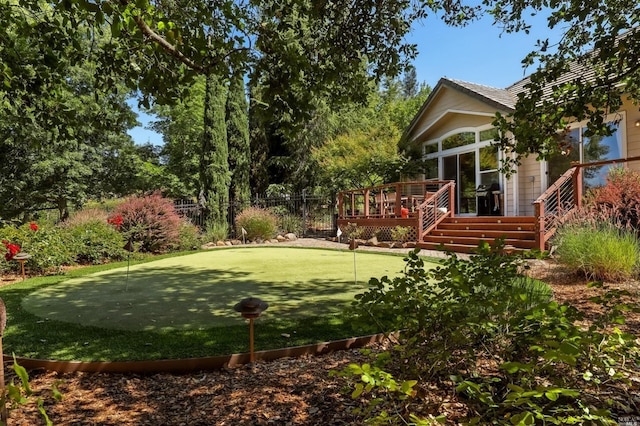 view of yard featuring a wooden deck and fence
