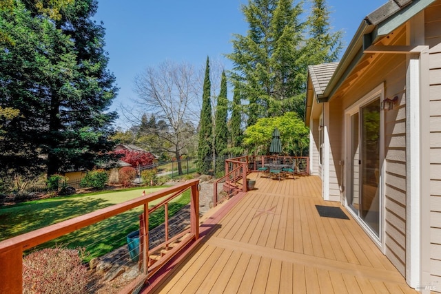 deck featuring a lawn and fence
