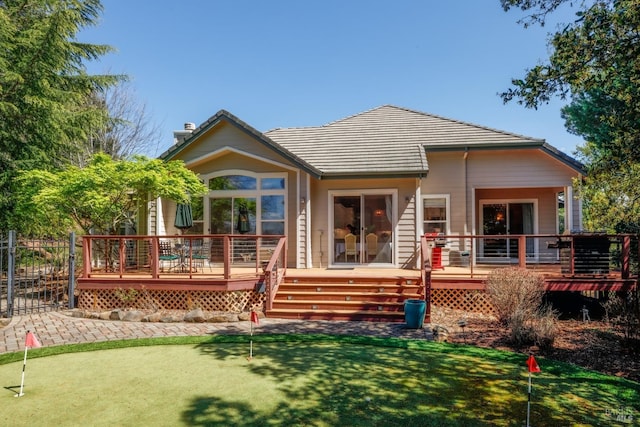 rear view of house featuring a chimney and a deck