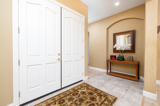 entrance foyer with baseboards, recessed lighting, and light tile patterned floors