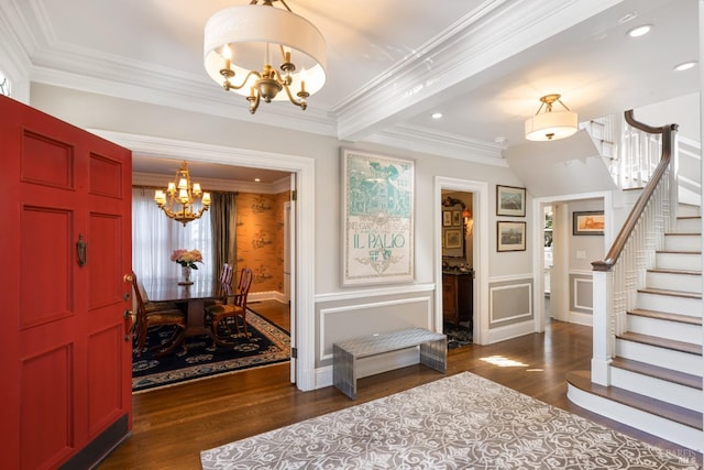 foyer entrance featuring crown molding, stairs, dark wood-style floors, recessed lighting, and a chandelier