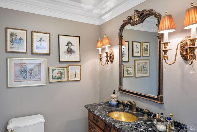 half bathroom with crown molding, vanity, and toilet
