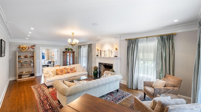 living area with an inviting chandelier, baseboards, a fireplace, and dark wood finished floors