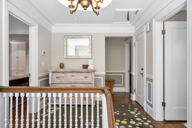 bedroom with crown molding, a decorative wall, a notable chandelier, and wood finished floors