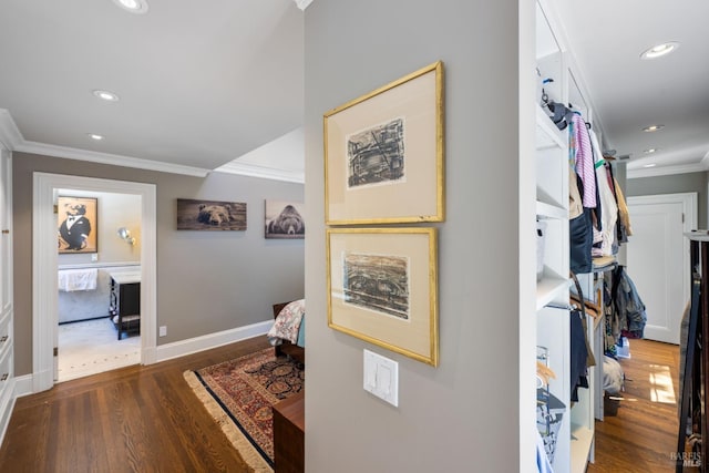 hallway featuring recessed lighting, baseboards, ornamental molding, and wood finished floors