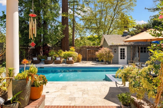 view of swimming pool featuring a fenced in pool, a patio, and a fenced backyard
