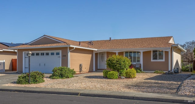 ranch-style house featuring driveway and an attached garage