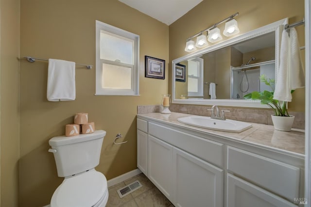 bathroom featuring a shower, tile patterned flooring, vanity, toilet, and visible vents