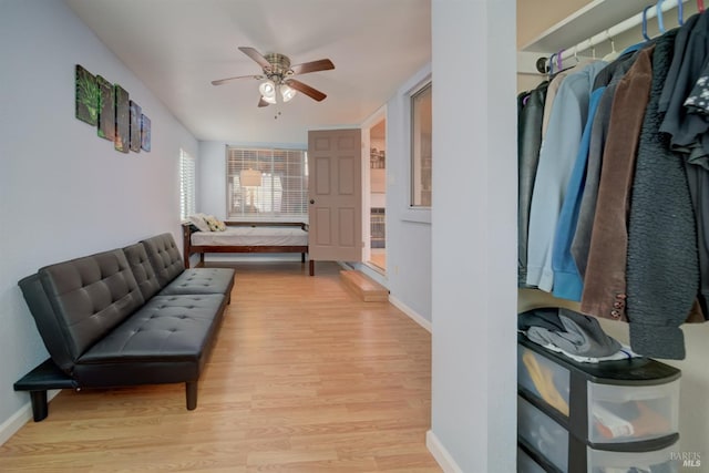hallway featuring baseboards and light wood-style floors