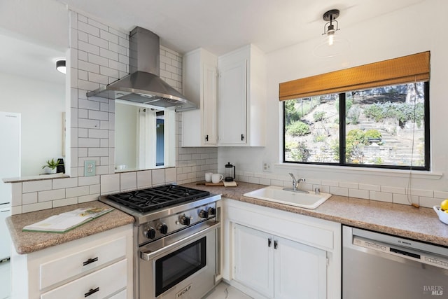 kitchen with wall chimney range hood, a sink, appliances with stainless steel finishes, marble finish floor, and backsplash