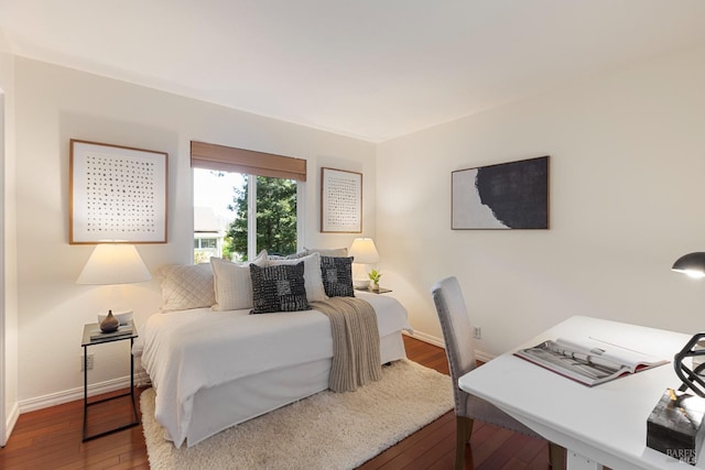 bedroom with hardwood / wood-style floors and baseboards