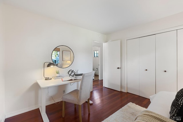 home office with dark wood-type flooring and baseboards